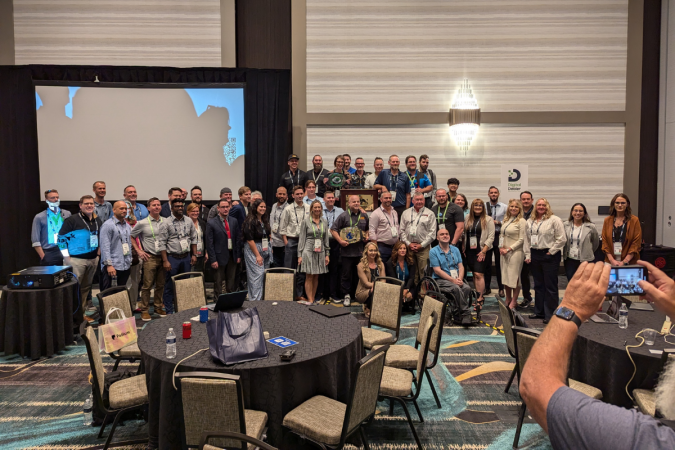 The participating teams for the Ultimate AI Hackathon line up for a picture.